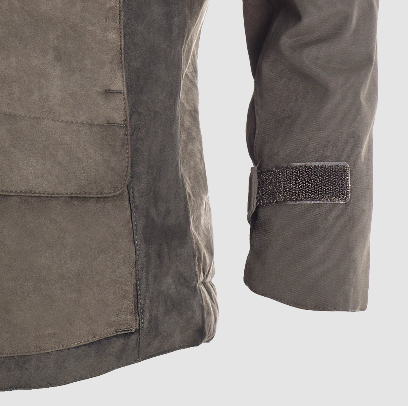 Close-up of the Hillman® PRE ORDER Fusion Hunting Jacket in gray suede with a large front pocket, Velcro cuff strap, and detailed stitching. Made from breathable Cordura for comfort, shown against a plain light background.
