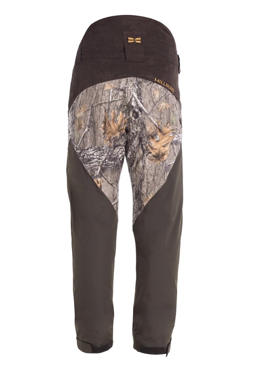 Rear view of Hillman® fusion waterproof hunting trousers with brown and green camouflage, reinforced black seat and lower legs, plus Velcro straps at the ankles.