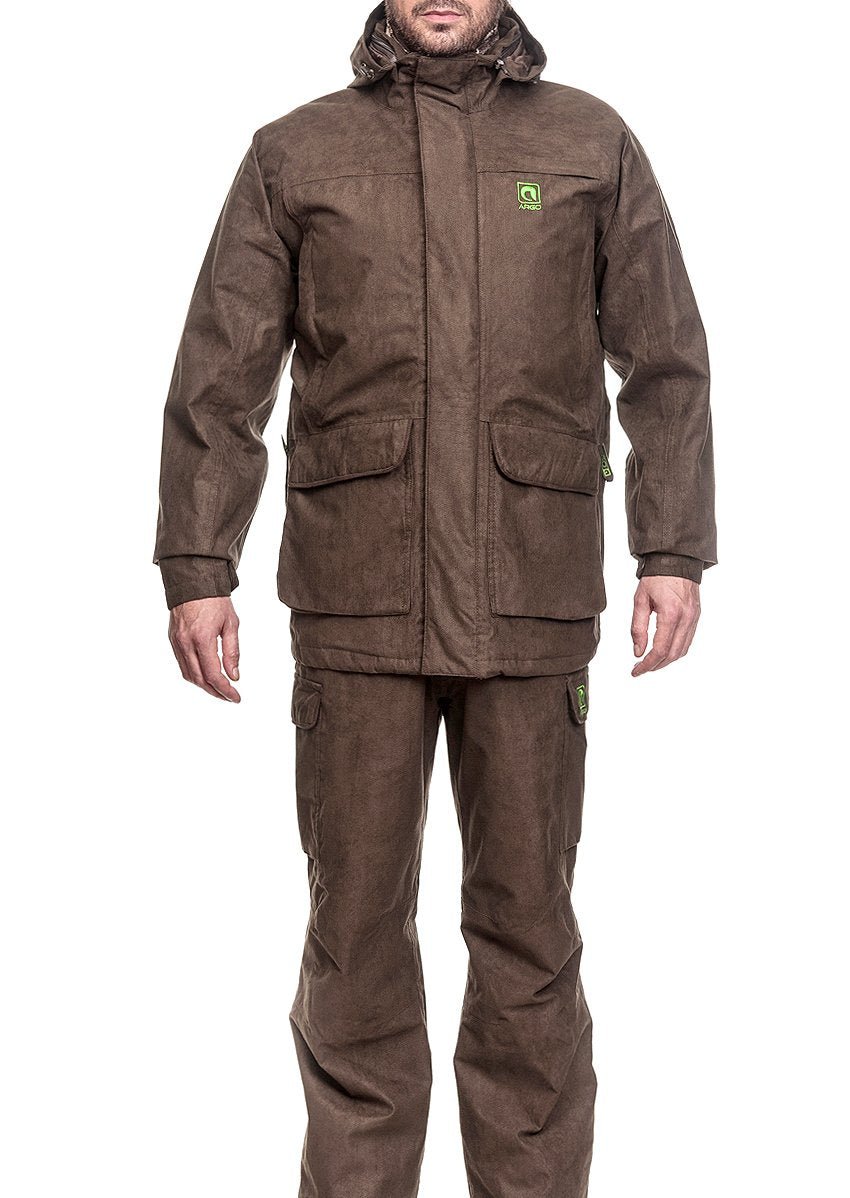 A person wears the WINTER SUIT ARGO® from Argo®, consisting of a brown outdoor jacket with a hood and large pockets, plus matching pants. The breathable waterproof design is ideal for hiking or cold weather. The face is not visible.