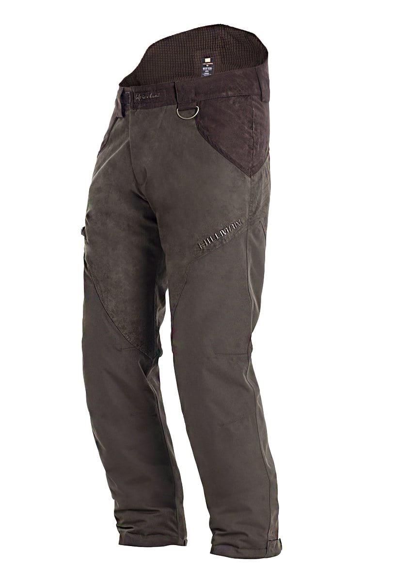 The Hillman® PRE ORDER Fusion Waterproof Hunting Trousers are dark brown, rugged pants with ergonomic, reinforced knee and thigh panels, an adjustable waistband, and a small D-ring near the right hip, shown standing upright on a white background.