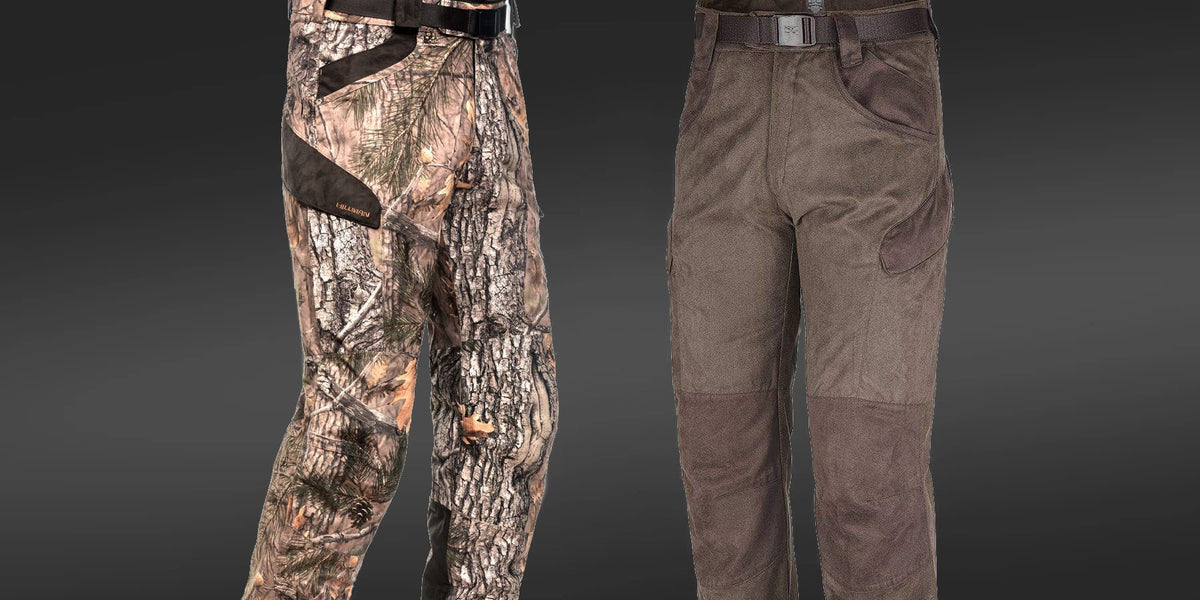 Two pairs of hunting pants are shown side by side: one with a camouflage tree-bark pattern, the other in solid brown with reinforced knee and pocket areas. Both have black belts and a dark background.
