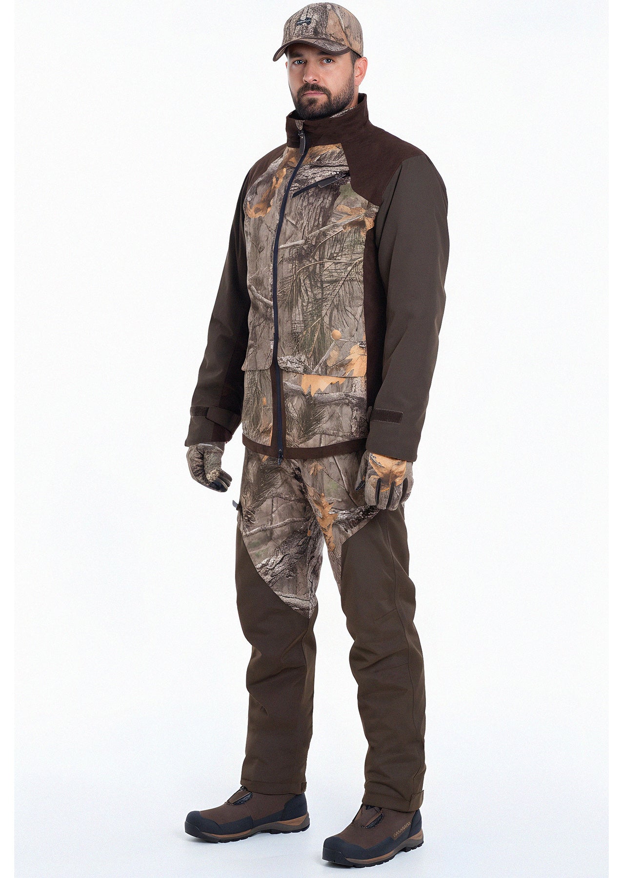 A man wears the Hillman® Fusion Hunting Jacket 3DX along with a matching camo cap and pants, standing against a plain white background facing forward with his hands relaxed at his sides.