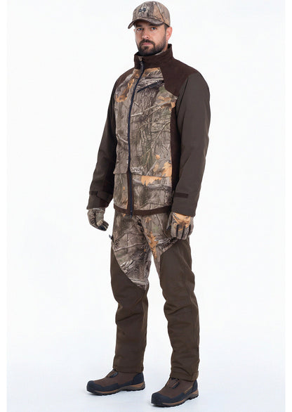 A man wears the Hillman® Fusion Hunting Jacket 3DX along with a matching camo cap and pants, standing against a plain white background facing forward with his hands relaxed at his sides.