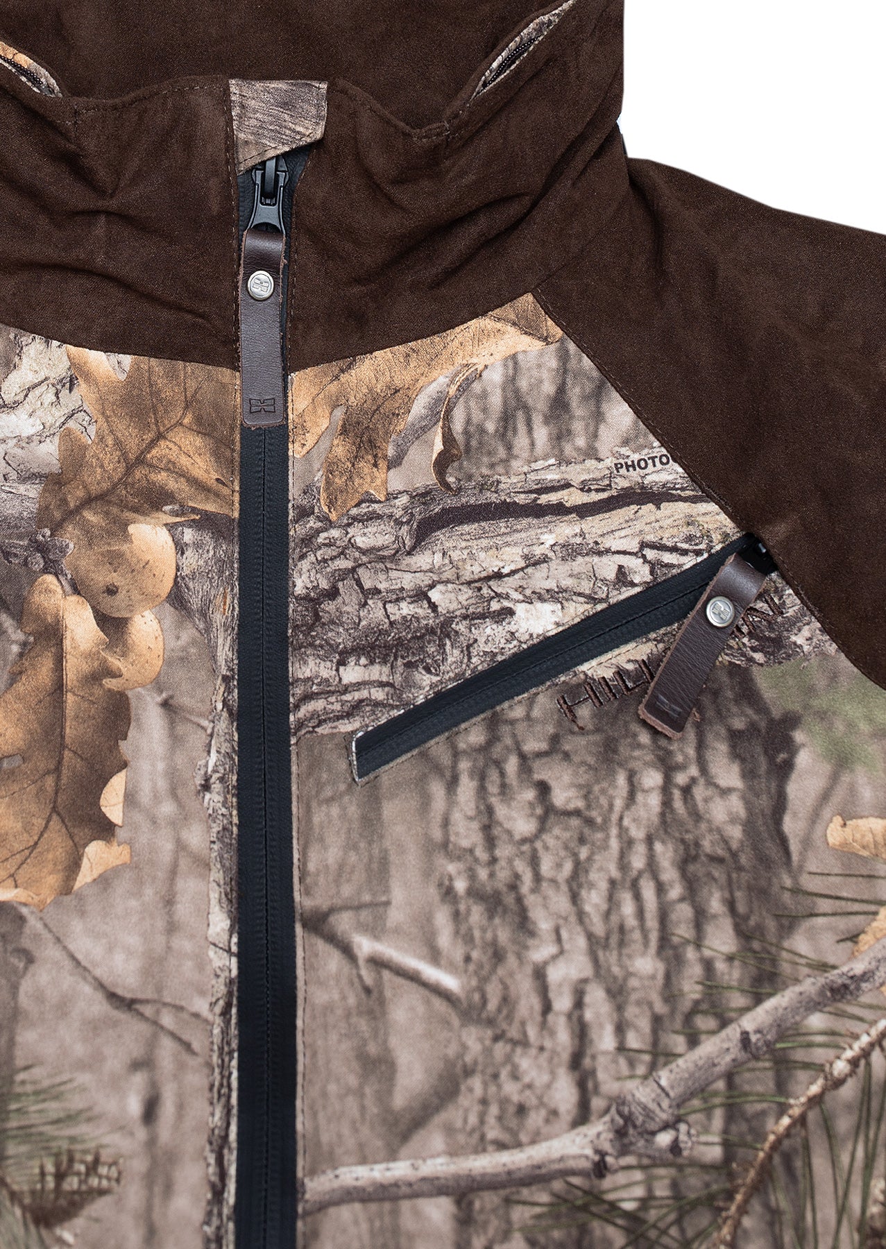 Close-up of the Hillman® Fusion Hunting Jacket 3DX shows a leafy and bark camo pattern, black central zipper with a leather pull, slanted zippered chest pocket, and dark brown upper section—perfect for blending in during outdoor pursuits.