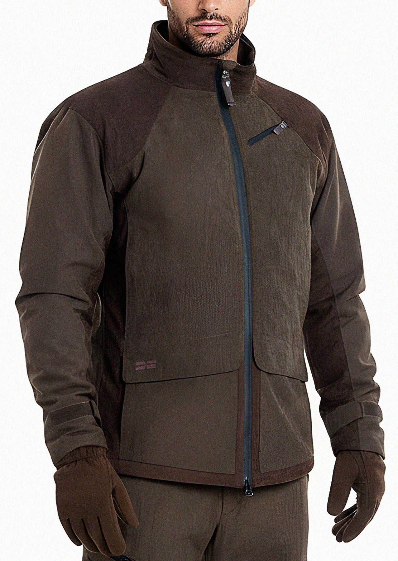 A person wears a Hillman® waterproof hunting jacket in brown with dark brown accents, matching gloves, and pants. The zip-up jacket features a high collar, chest pocket, and two large front pockets. Their face is partially visible.