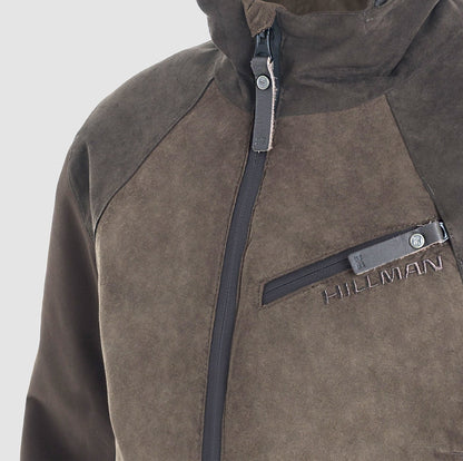 Close-up of a brown and dark gray PRE ORDER Fusion Hunting Jacket by Hillman® featuring a waterproof design, front zipper, and zipped chest pocket. The brand name Hillman® is embroidered above the chest pocket.
