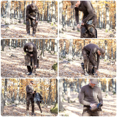 A man in the forest, surrounded by autumnal trees and fallen leaves, wears HILLMAN GEARs 5WL Ultra-Lightweight Waterproof Hunting Trousers and adjusts his outfit under a hat.